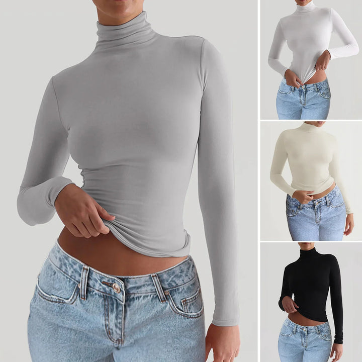 Woman wearing slim-fit turtleneck long sleeve tops in gray, white, cream, and black paired with blue jeans