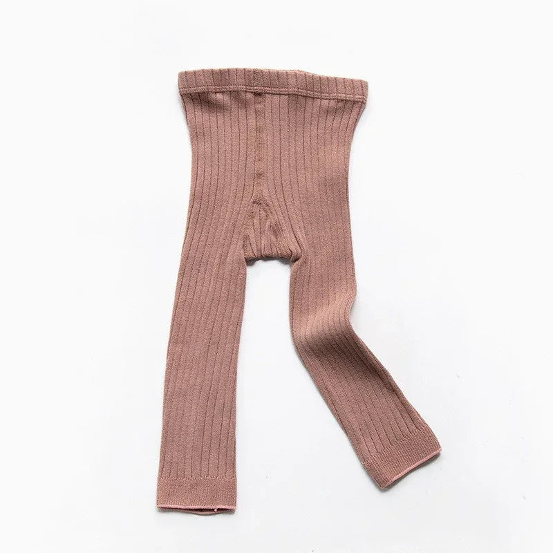 Pink ribbed knit baby leggings laid flat on white background