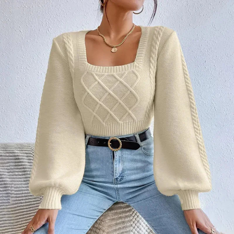 Woman wearing cream cable knit sweater with balloon sleeves and square neckline paired with high-waist jeans