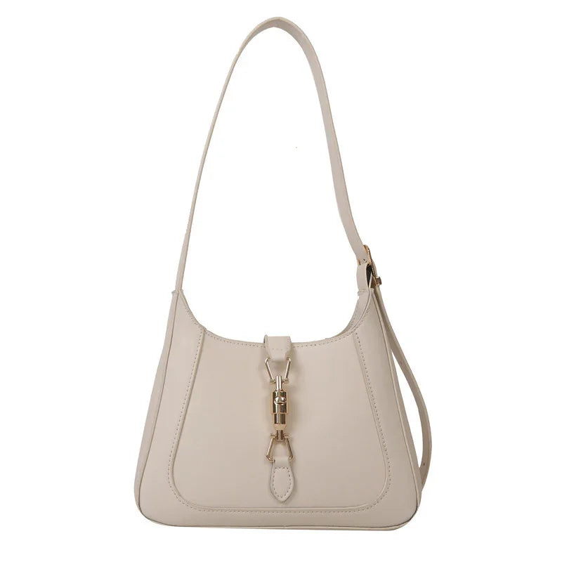 Elegant beige leather shoulder bag with gold-tone clasp and adjustable strap