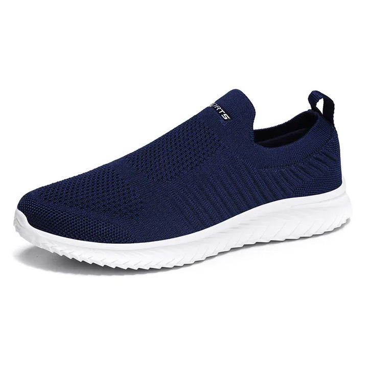 Navy blue slip-on sneaker with breathable knit upper and white textured sole