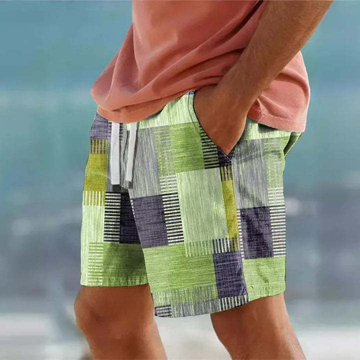 Man wearing green and gray patchwork shorts with white drawstring and coral t-shirt