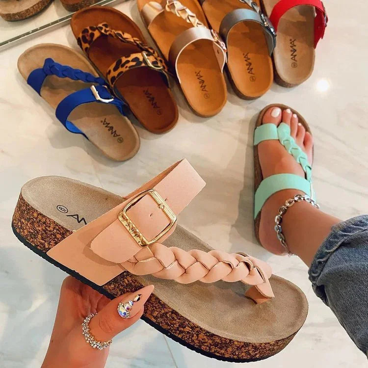 Various stylish braided strap sandals in pink, blue, leopard print, tan, black, and red on marble floor, worn mint green sandal