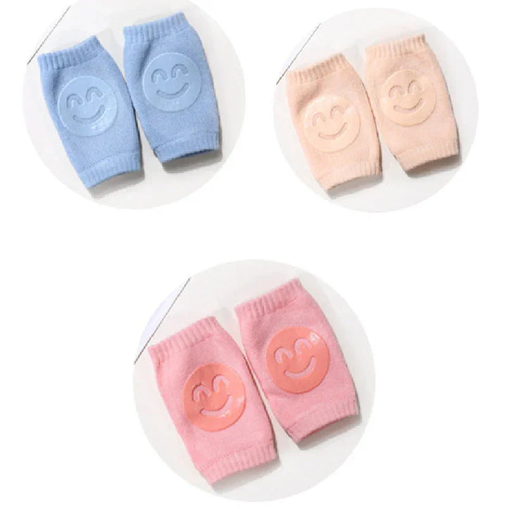 Soft knitted knee pads for babies in blue, beige, and pink with smiley face grips
