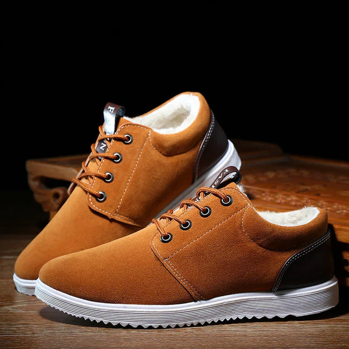 Brown casual lace-up shoes with white fur lining and white rubber soles on wooden surface