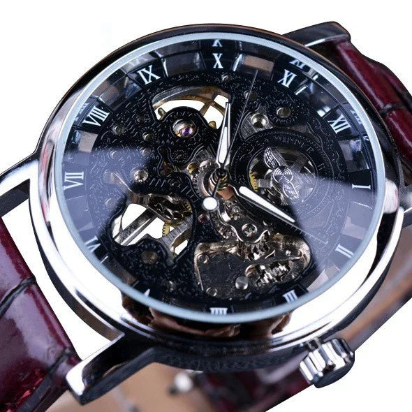 Close-up of luxury skeleton mechanical wristwatch with silver case and brown leather strap showing visible gears and Roman numerals