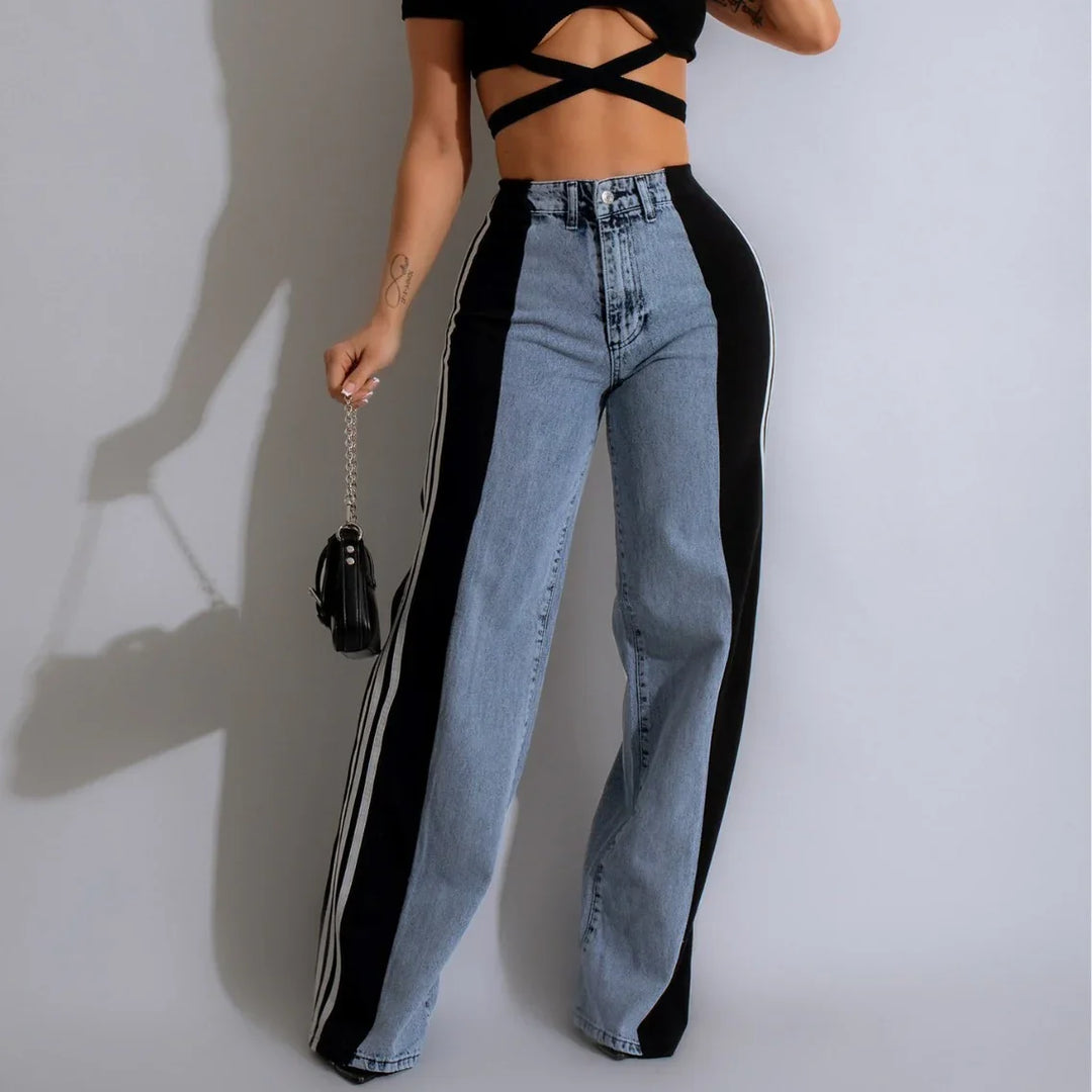 High-waisted two-tone jeans with black side stripes, worn with a black crisscross crop top and small handbag