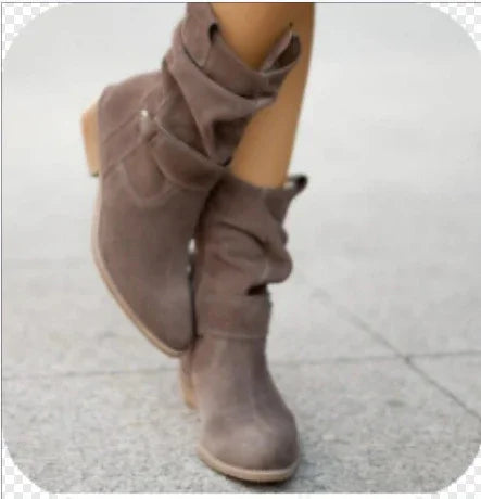 slouchy brown suede ankle boots with wooden stacked heels on pavement