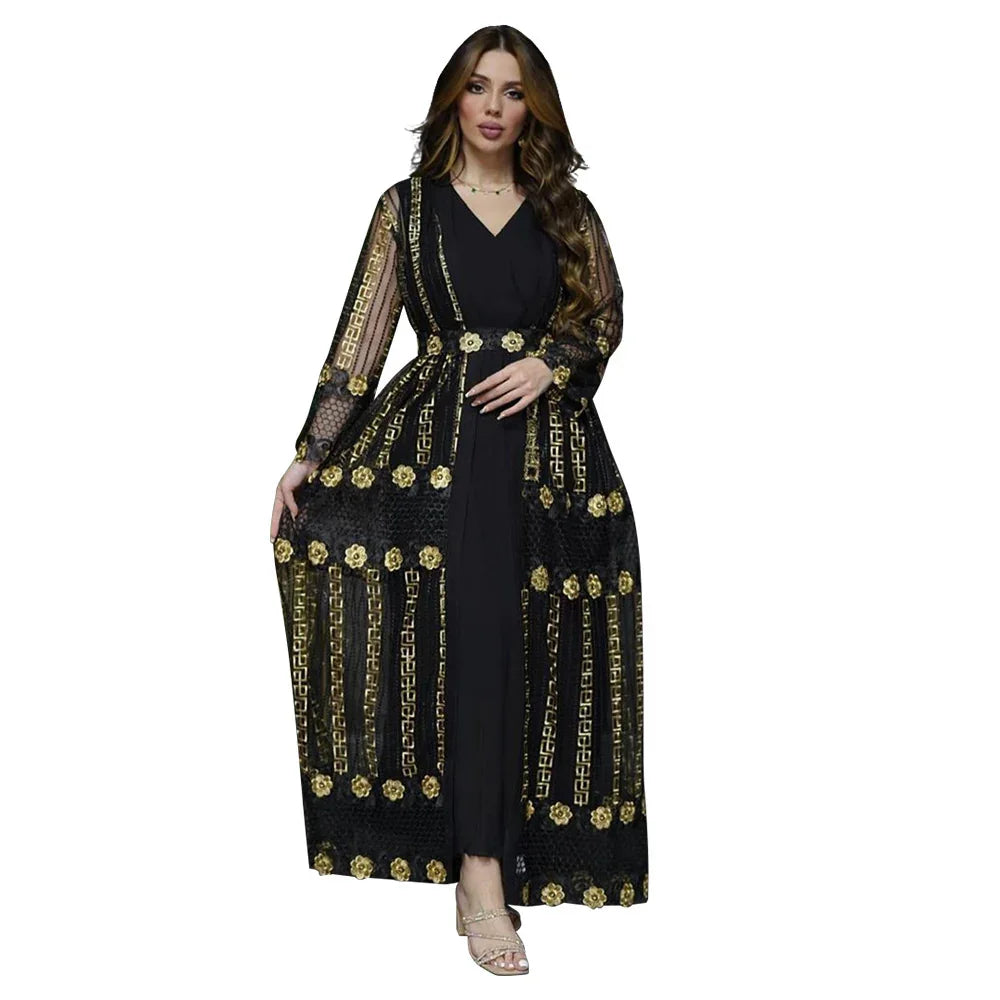 Woman wearing black maxi dress with sheer long sleeves and gold floral embroidery