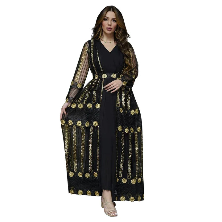 Woman wearing black maxi dress with sheer long sleeves and gold floral embroidery