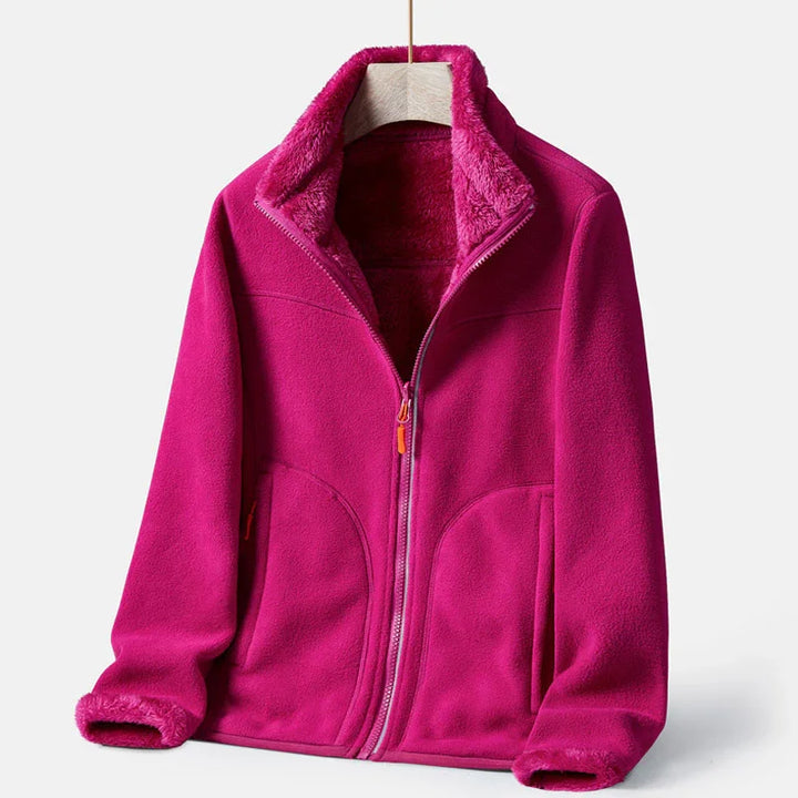 Pink fleece jacket with soft plush lining, full zipper, and front pockets on hanger