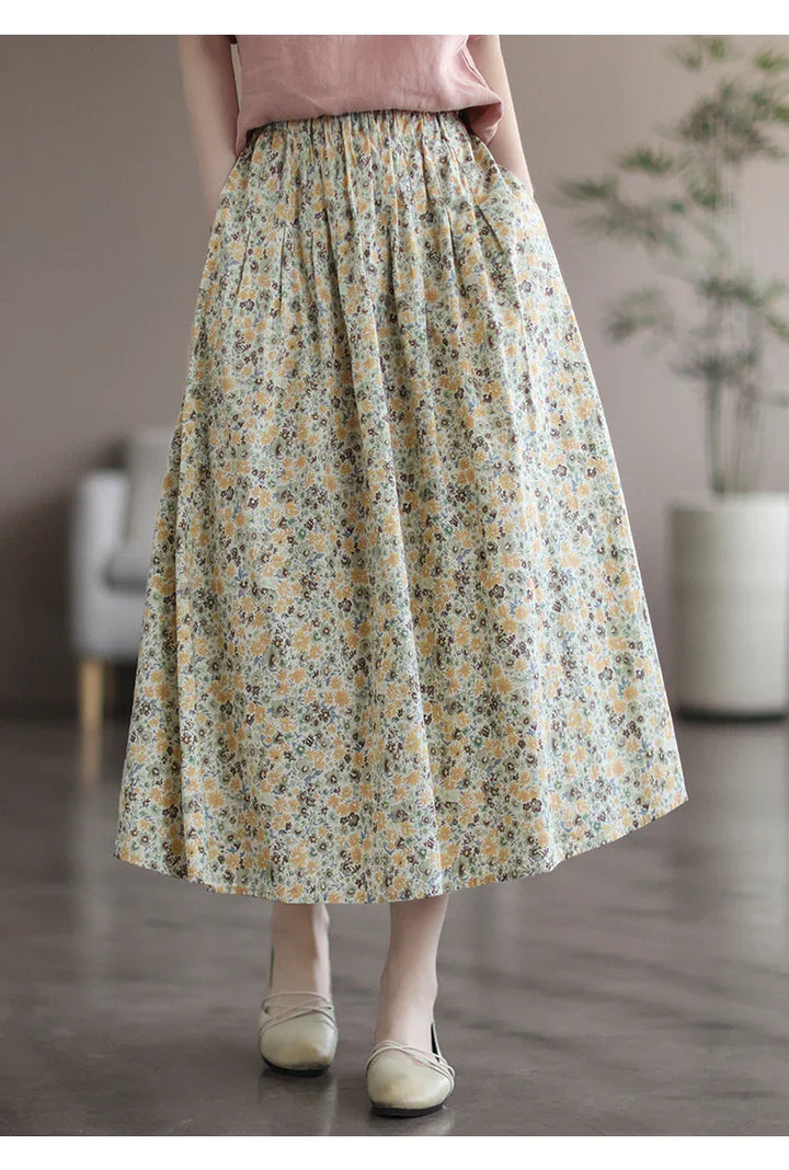 Woman wearing floral midi skirt with pockets, paired with beige ballet flats indoors