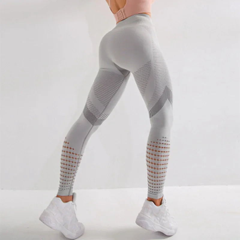 Woman wearing light gray seamless textured leggings and white sneakers against white background