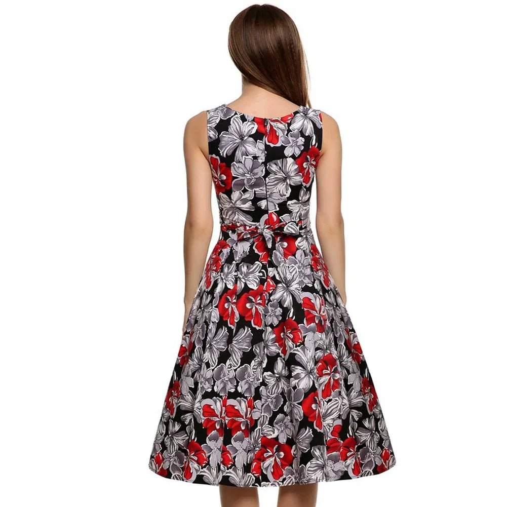 Woman wearing sleeveless black dress with red and white floral print, back view