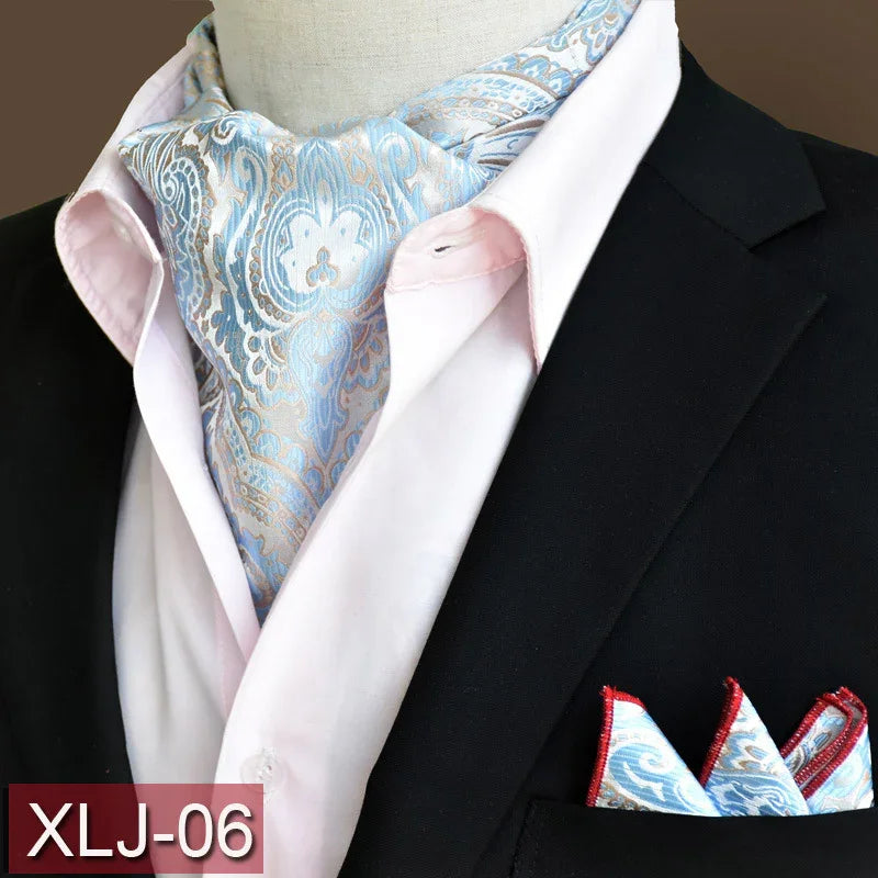 Blue and silver paisley ascot scarf paired with black blazer and matching pocket square on mannequin