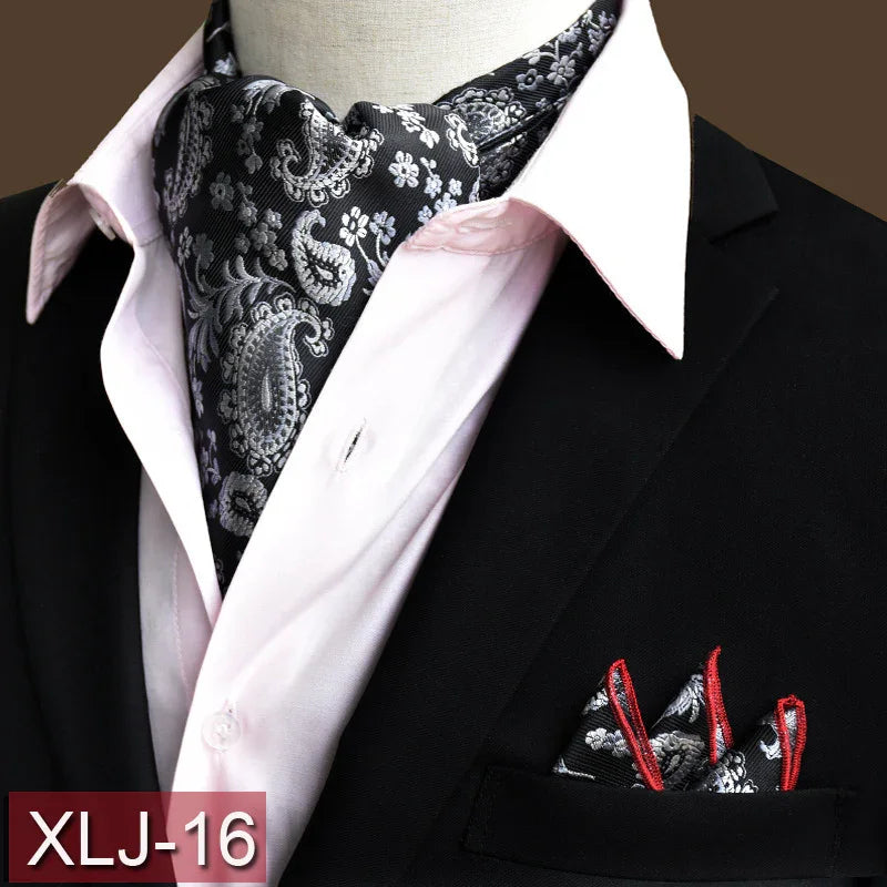 Black paisley silk ascot scarf with red-trimmed pocket square on black suit and light pink dress shirt