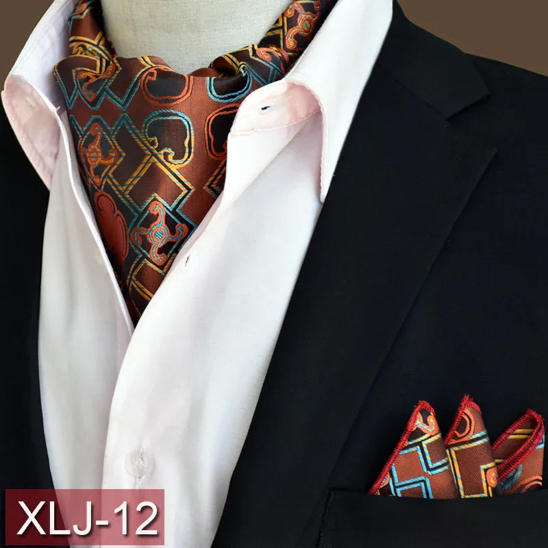 Brown patterned ascot and matching pocket square with blue and orange accents on black suit jacket and white shirt