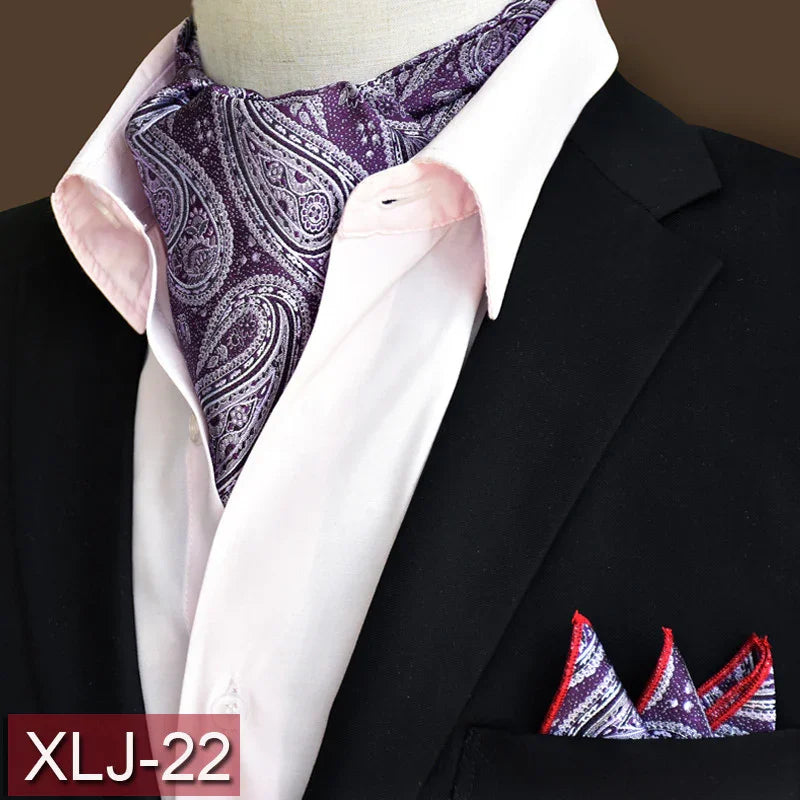 Black suit jacket with white shirt and purple paisley ascot and matching pocket square