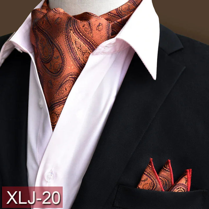 Elegant orange paisley ascot tie and matching pocket square on white shirt and black blazer