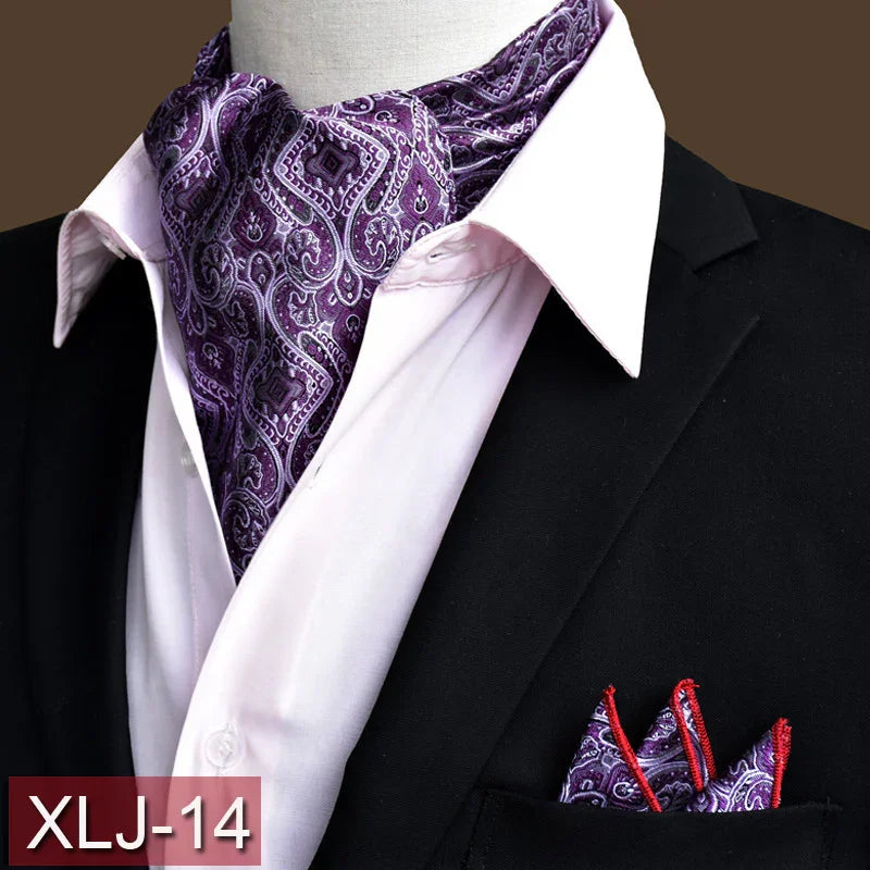 purple paisley ascot tie and pocket square with red trim on white shirt and black suit jacket
