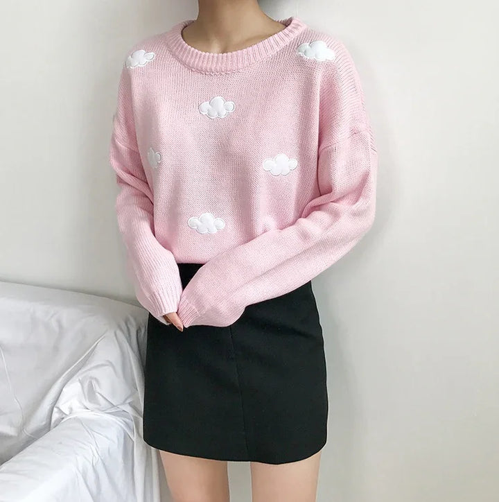 Woman wearing pink sweater with white cloud patterns and black mini skirt indoors