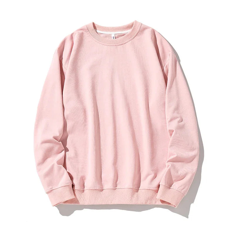 Soft pink crewneck sweatshirt with long sleeves and ribbed cuffs isolated on white background