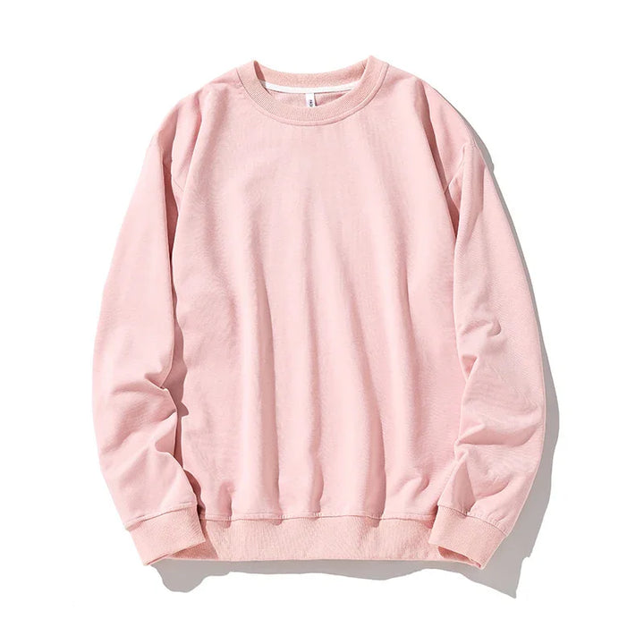 Soft pink crewneck sweatshirt with long sleeves and ribbed cuffs isolated on white background