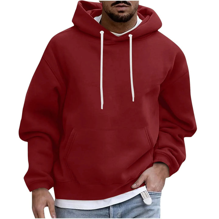 Man wearing a plain red hooded sweatshirt with white drawstrings and front pocket