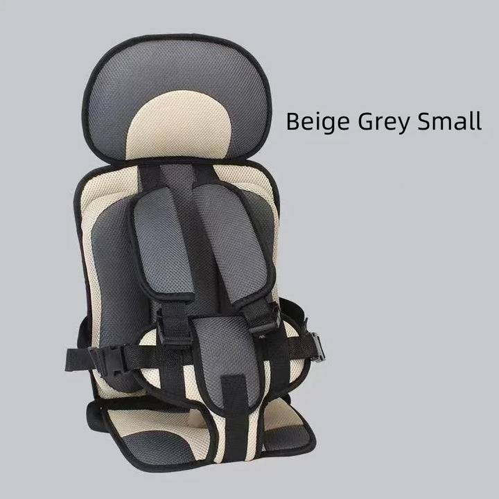Beige and grey small child safety car seat with harness and headrest on gray background