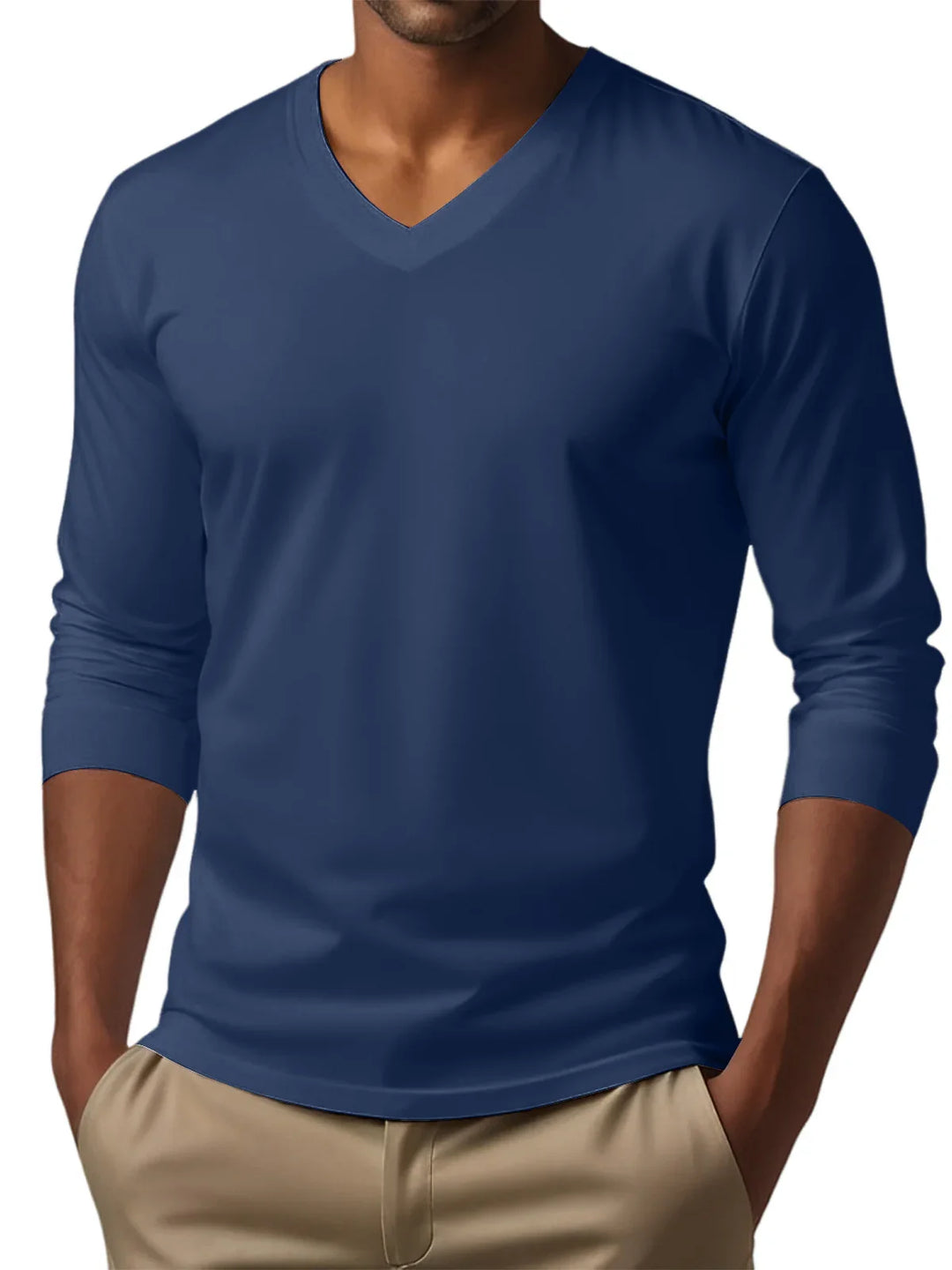 Man wearing a navy blue V-neck long sleeve shirt paired with beige pants