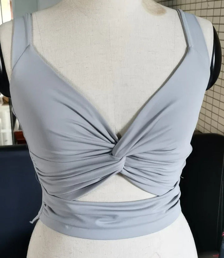 Light grey twisted front crop top with spaghetti straps displayed on mannequin