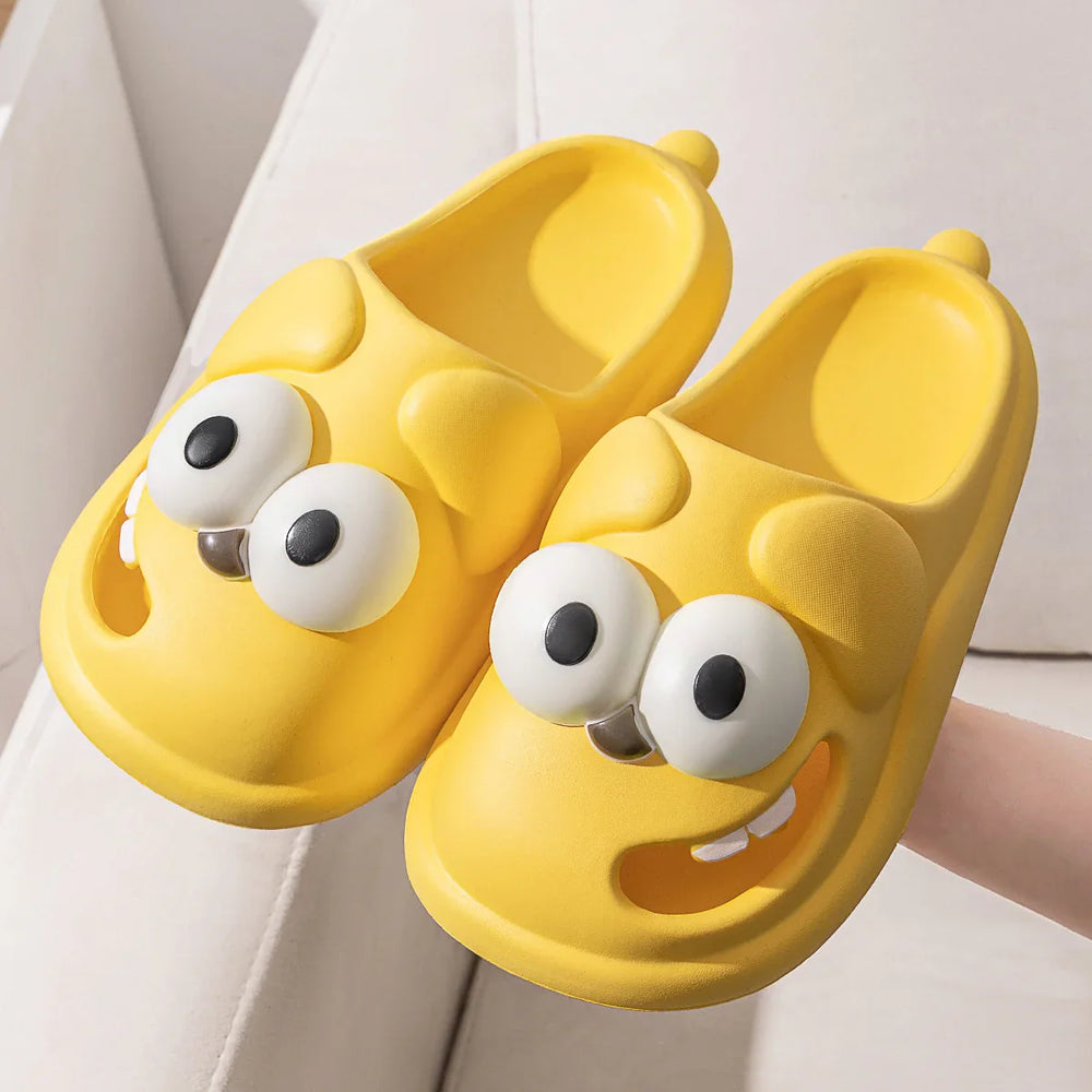 Bright yellow cartoon dog face slippers with large eyes and smiling expression