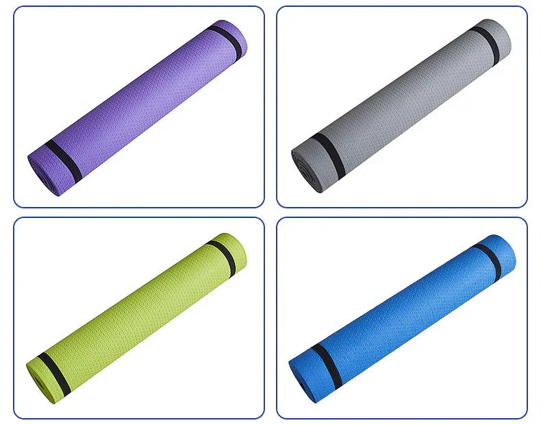 Four rolled yoga mats in purple, gray, green, and blue, each with a black strap.
