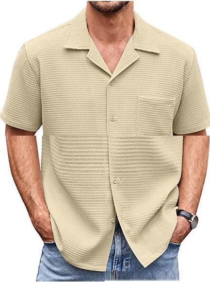 Men's beige short sleeve textured casual shirt paired with blue jeans and wristwatch