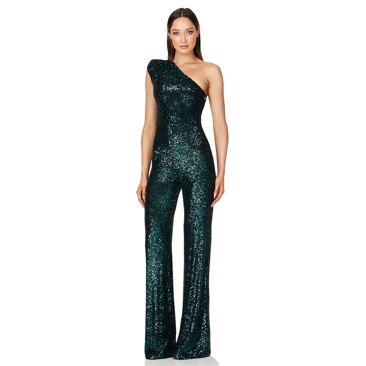 Woman in sparkling dark green one-shoulder sequin jumpsuit with wide-leg pants