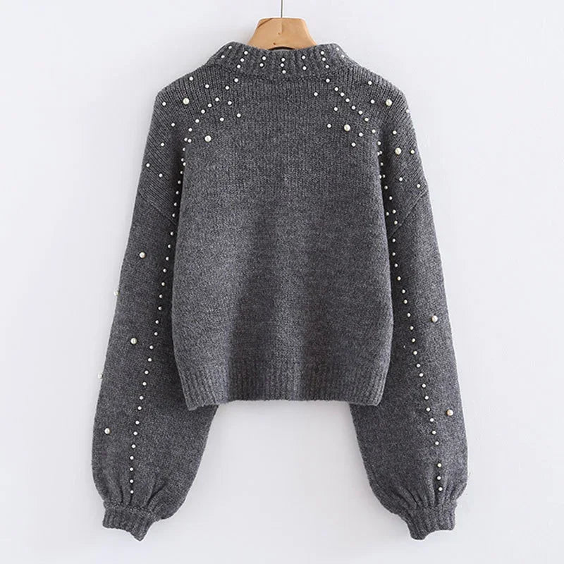 Gray knitted sweater with pearl embellishments on sleeves and shoulders, ribbed cuffs and hem