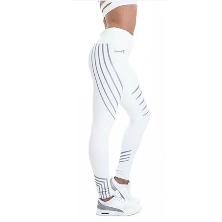 Woman wearing white high-waisted leggings with gray geometric stripes and white sneakers