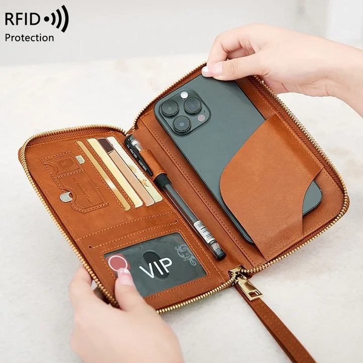 Brown leather RFID protection wallet organizer holding a smartphone, pen, credit cards, and VIP card