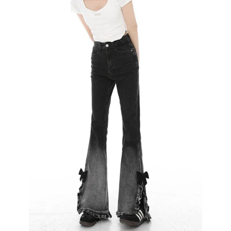 Woman wearing high-waisted black ombre flared jeans with bow details and white top