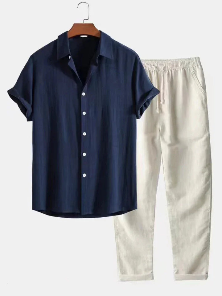 Men's navy blue short sleeve button-up shirt with white casual drawstring pants