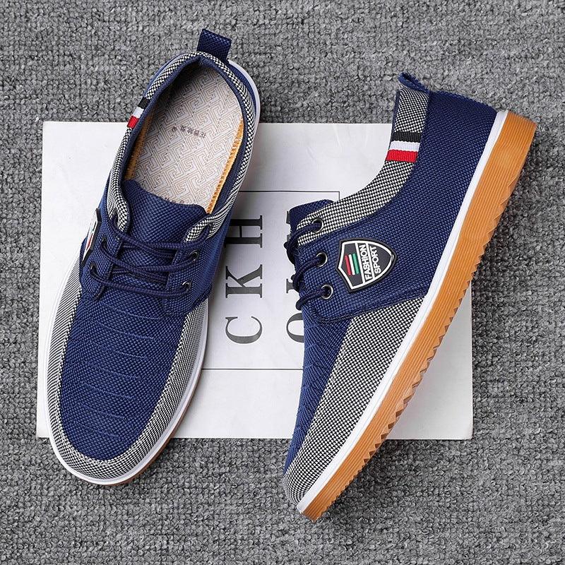 Blue and white casual sneakers with gum sole and fashion sport logo on gray carpet