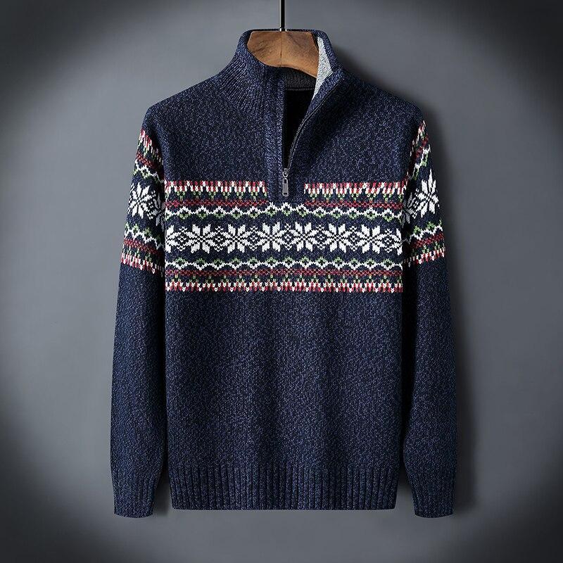 Navy blue knit sweater with half-zip and white snowflake pattern across chest and sleeves
