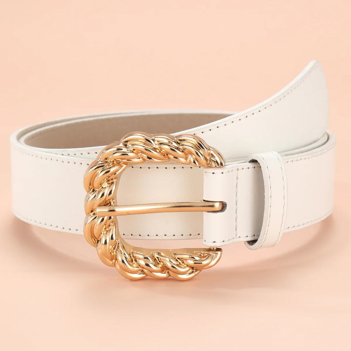 White leather belt with a shiny gold twisted rope-style buckle on a beige background