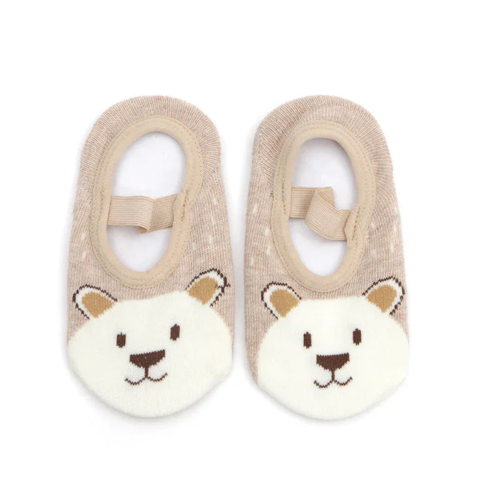 Beige baby socks with cute bear face design and elastic strap on white background