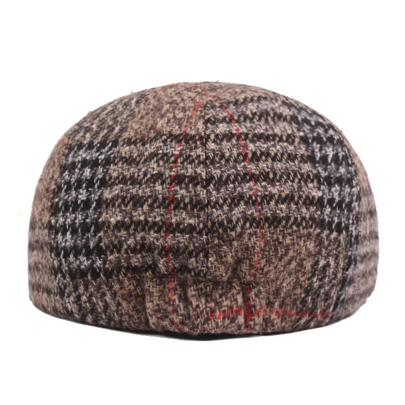 Brown and black tweed flat cap with red checkered pattern on white background