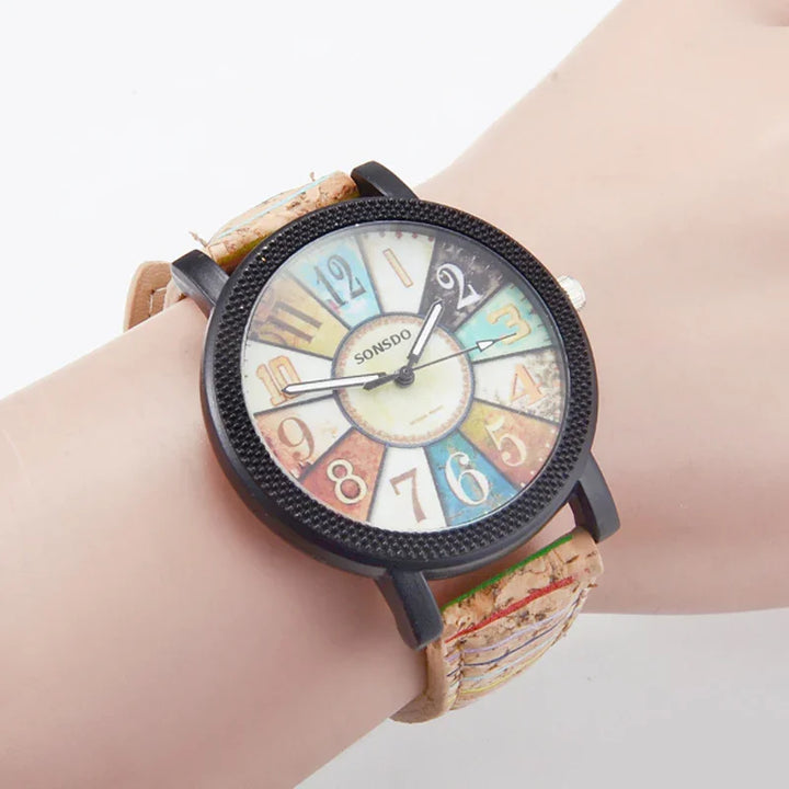 Vintage style wristwatch with colorful numbered dial and black textured bezel on leather strap