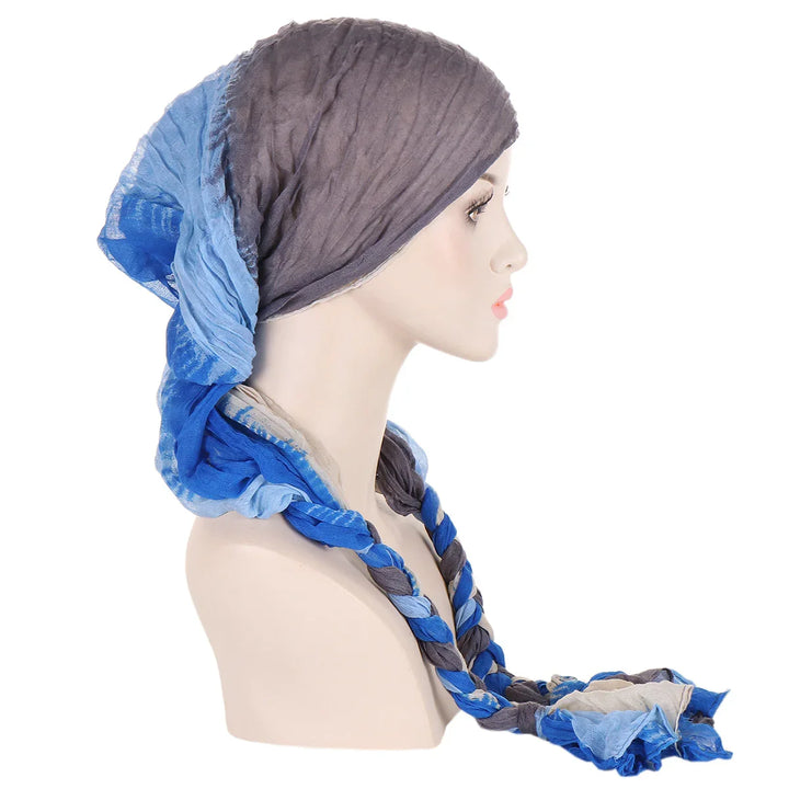 Side view of mannequin wearing a twisted multi-shade blue and gray cotton headscarf