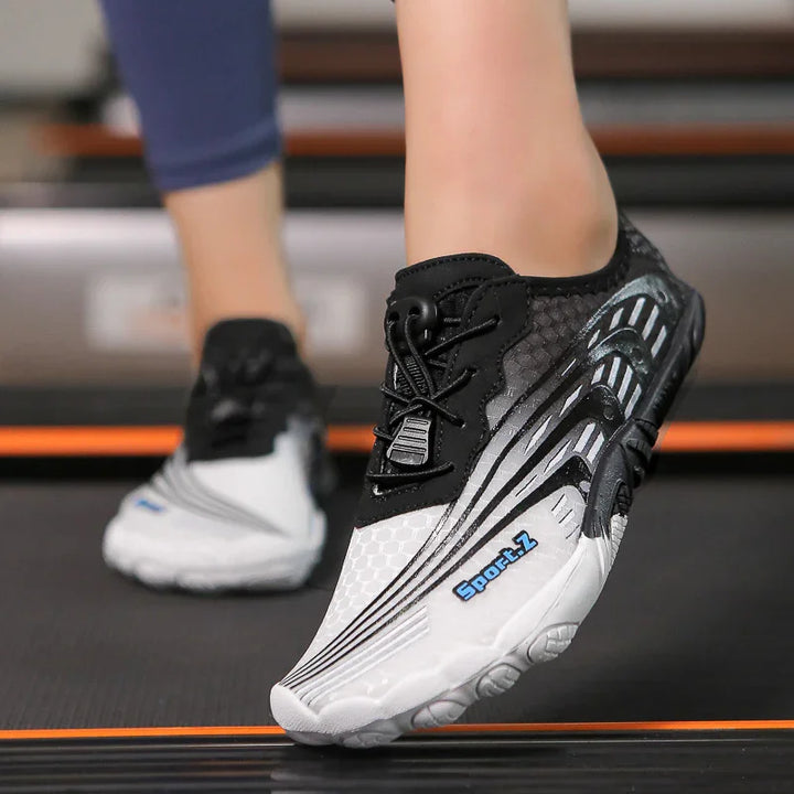Close-up of black and white Sport-Z running shoes with blue logo on treadmill