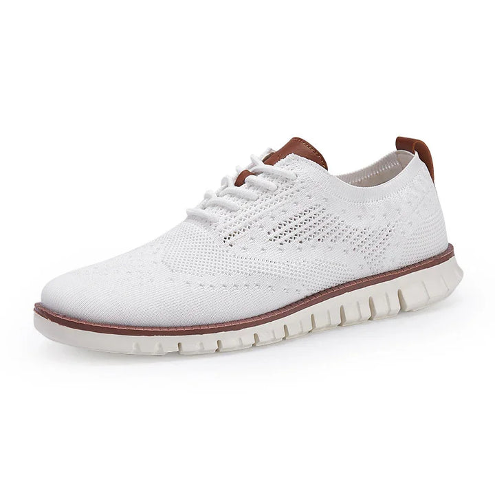 White knitted casual sneaker with brown accents and flexible white sole on white background