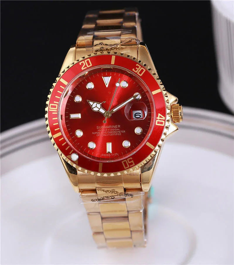 Gold wristwatch with red dial and bezel, featuring date display and luminous markers